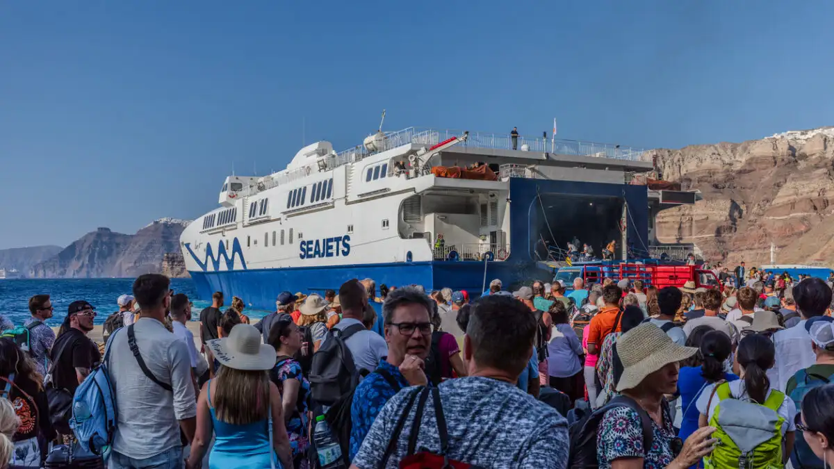 Άνθρωποι σε λιμάνι περιμένουν την επιβίβαση σε πλοίο για διακοπές