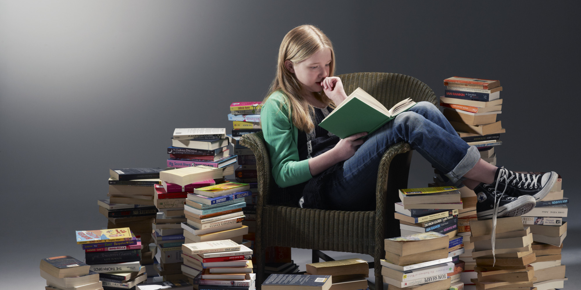 girl-reading-pile-of-books.jpg