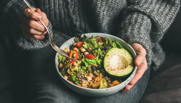 woman-eating-healthy-vegetarian-dinner-from-buddha-bowl-close-up.jpg