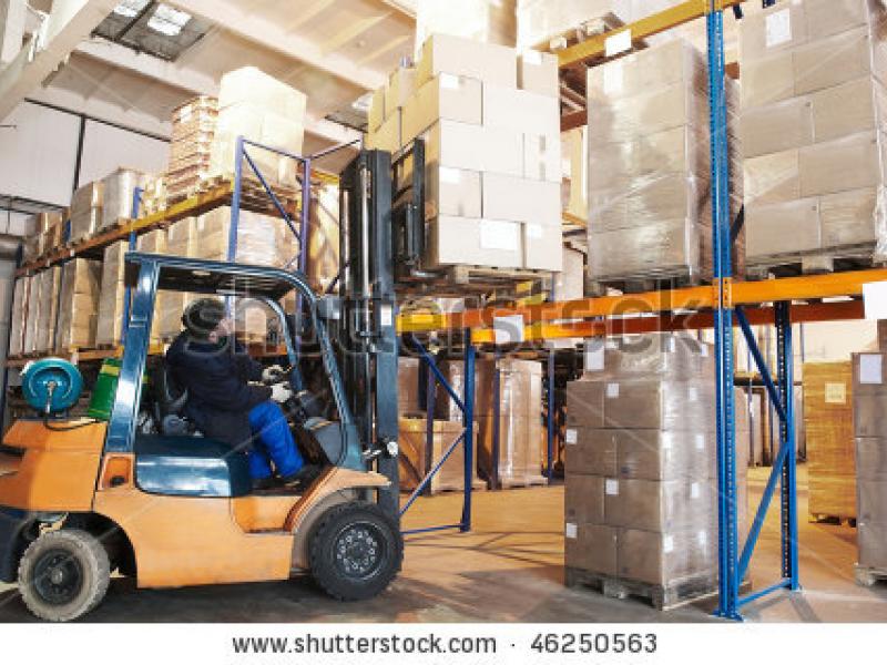 stock-photo-worker-driver-of-a-forklift-loader-at-warehouse-loading-cardboard-boxes-on-pallet-to-shelves-46250563.jpg