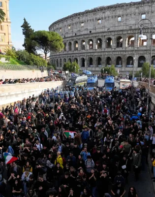 Antiwar activists demonstrate against rearmament and Italy's involvement in wars in front of the Colosseum in Rome, Saturday, Oct. 24, 2026, during one of several protests in Italy organized by groups across the political spectrum