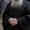 Ιερέας που δεν φαίνεται το πρόσωπό του και φοράει άμφια έχει τα χέρια του σταυρωμένα