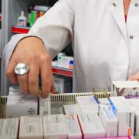 Φαρμακοποιός ψάχνει φάρμακα σε συρτάρι φαρμακείου
