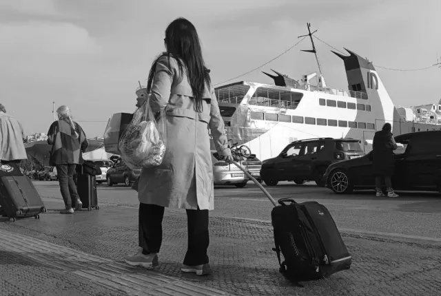 Γυναίκα εκπαιδευτικός αναπληρώτρια με βαλίτσα στο χέρι ετοιμάζει να μπει σε καράβι