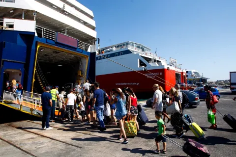 Επιβίβαση τουριστών με βαλίτσες σε καράβι στον Πειραιά για διακοπές
