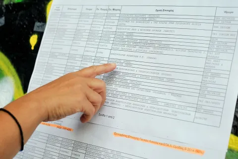 Υποψήφιος στις Πανελλαδικές εξετάσεις κοιτάζει τις βάσεις σε πίνακα