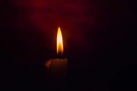 Αναμμένο κερί σε μαύρο φόντο