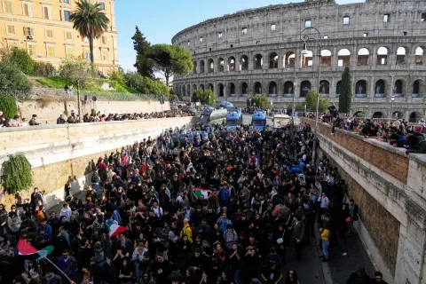 Antiwar activists demonstrate against rearmament and Italy's involvement in wars in front of the Colosseum in Rome, Saturday, Oct. 24, 2026, during one of several protests in Italy organized by groups across the political spectrum